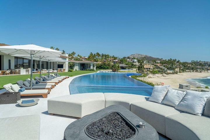 Sunken lounge with fire pit near the pool and beach at a Palmilla estate